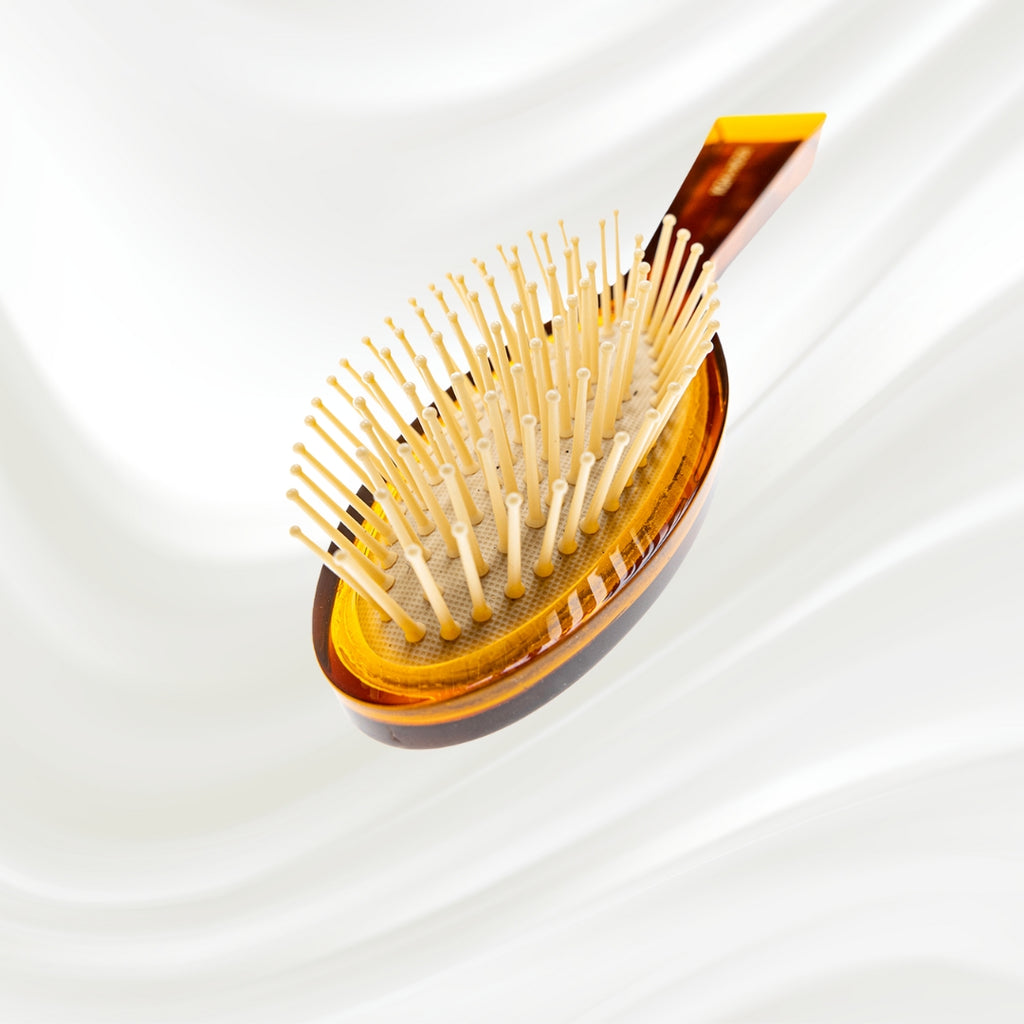 107G KOH-I-NOOR Jaspe small oval hairbrush with brown tortoiseshell acetate handle, and synthetic pins; KOH-I-NOOR's gold logo stamped on the handle