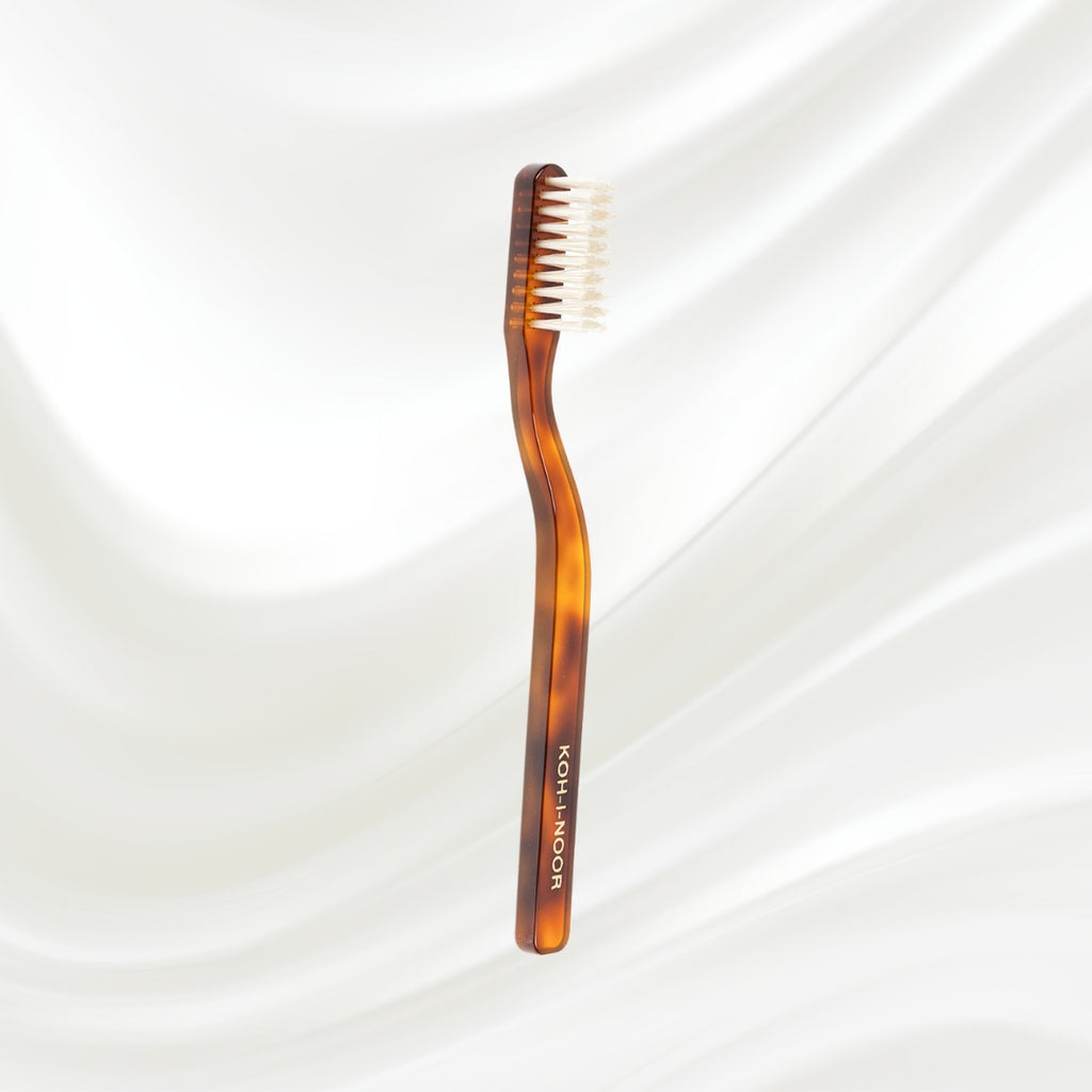 Tortoiseshell toothbrush with 'Koh-I-Noor' branding on a white background