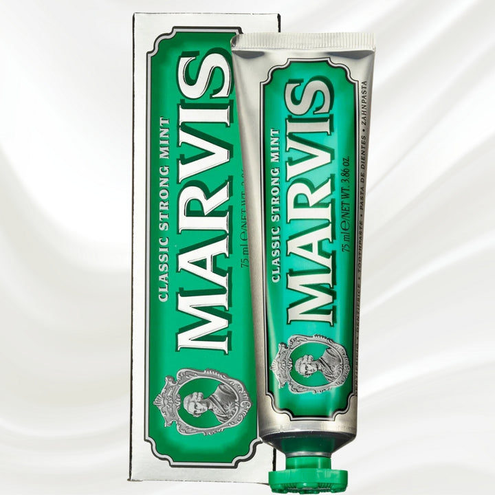 Two green tubes of Marvis toothpaste on a white background